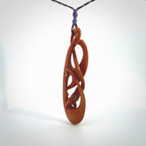 This necklace is carved from cow bone and stained with a homemade tea dye. It is a unique piece of wearable art that is sure to catch the eye. The shape is a complex twist form and has been beautifully hand carved by bone carver Yuri Terenyi.